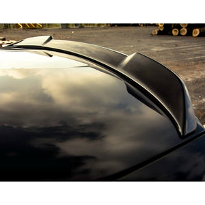 Close up of a AutoTecknic Carbon Fiber Trunk Spoiler on a black BMW